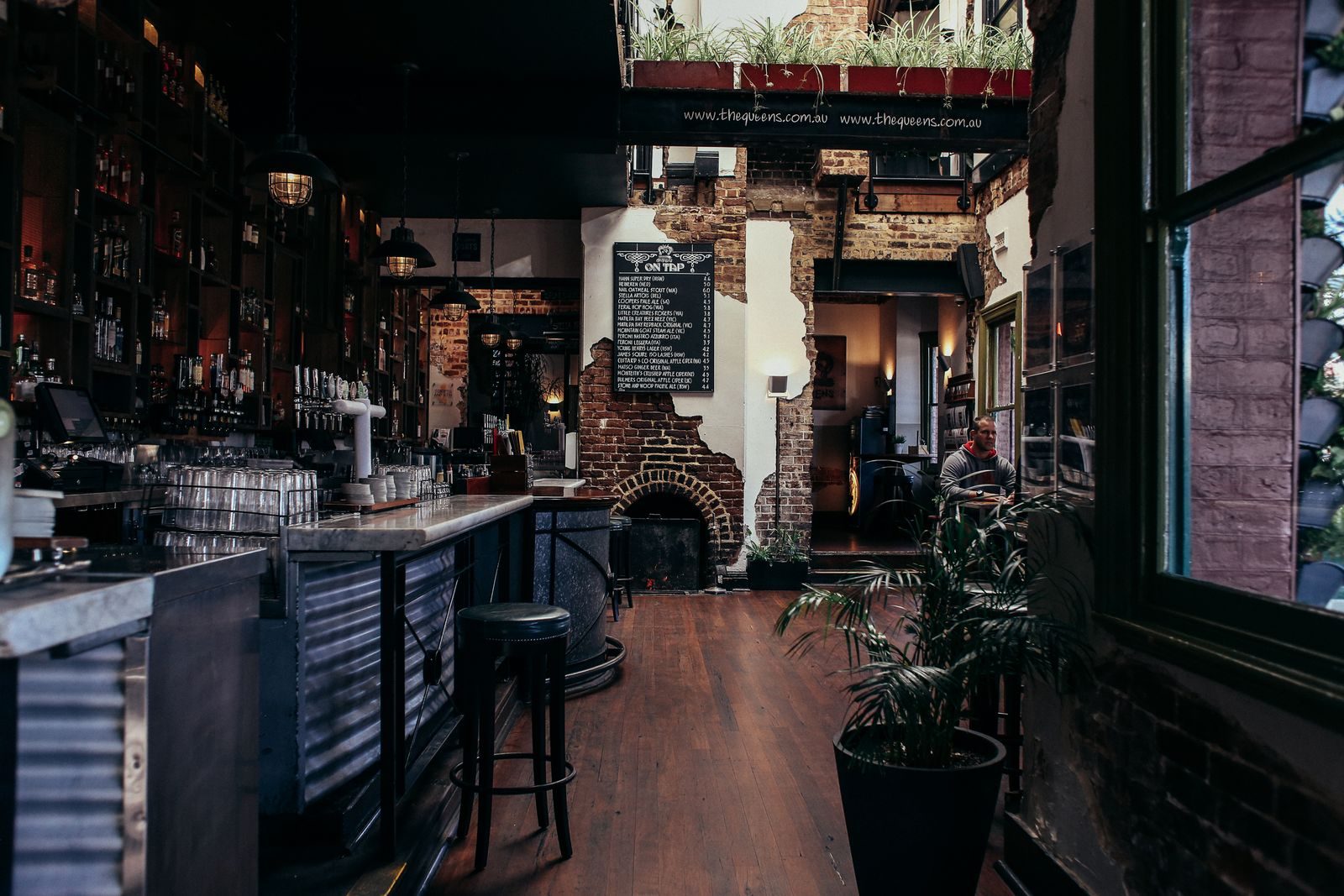 A neighborhood pub interior with a long wooden counter and seating.