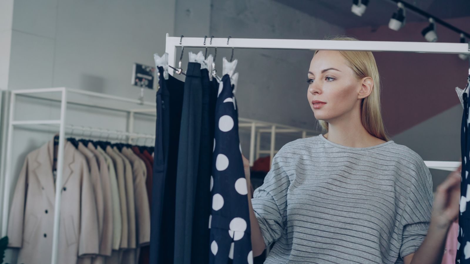 A customer browsing clothing racks inside a boutique.