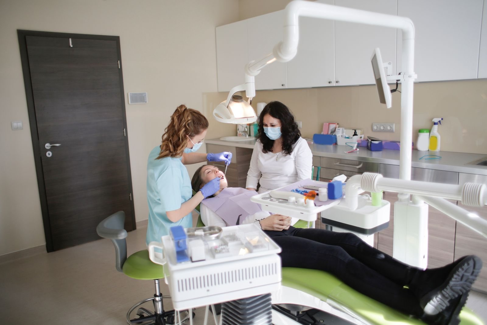 A dental professional treating a patient in a modern clinic.