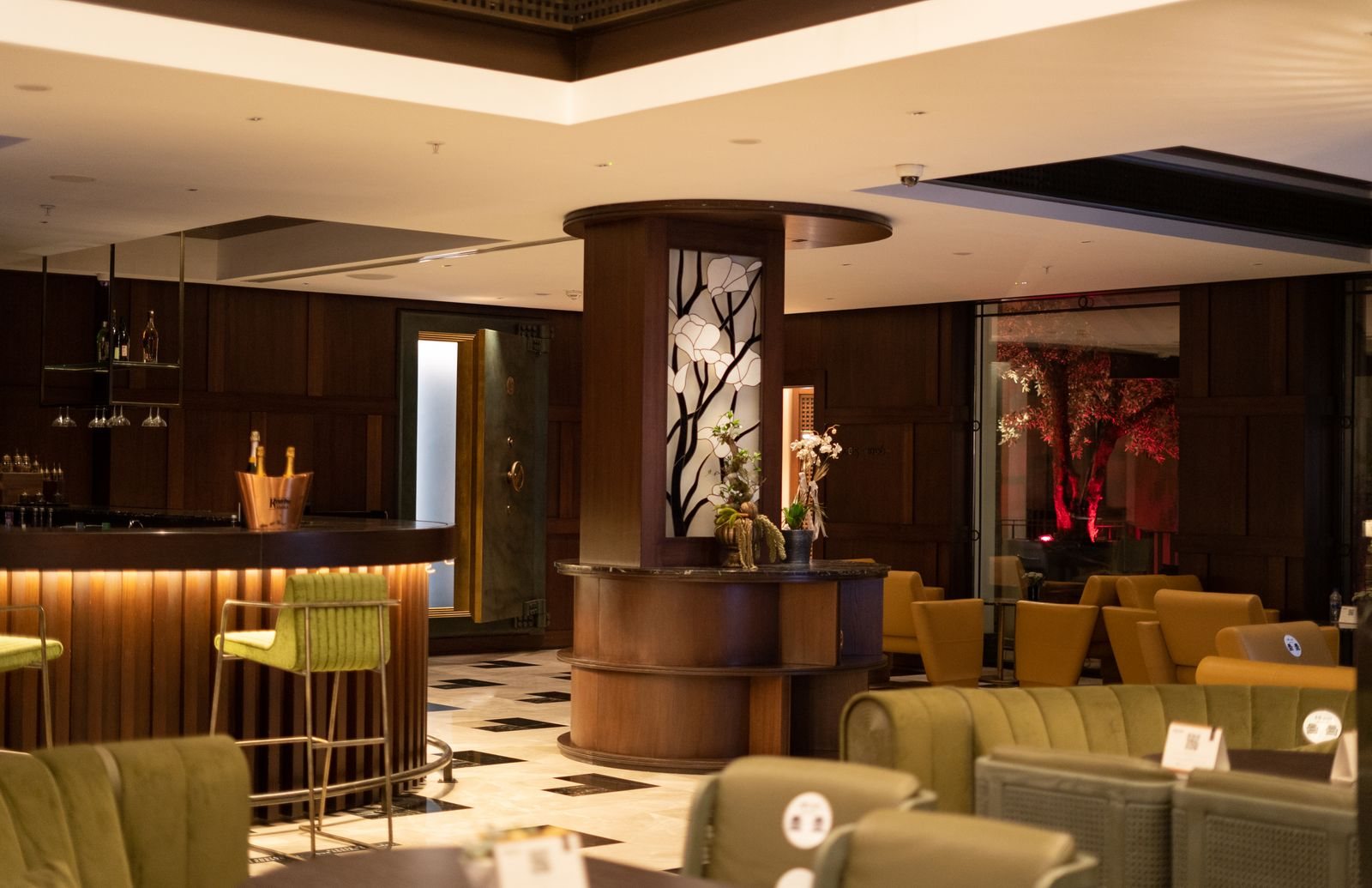 A hotel lobby with modern furnishings and warm lighting.
