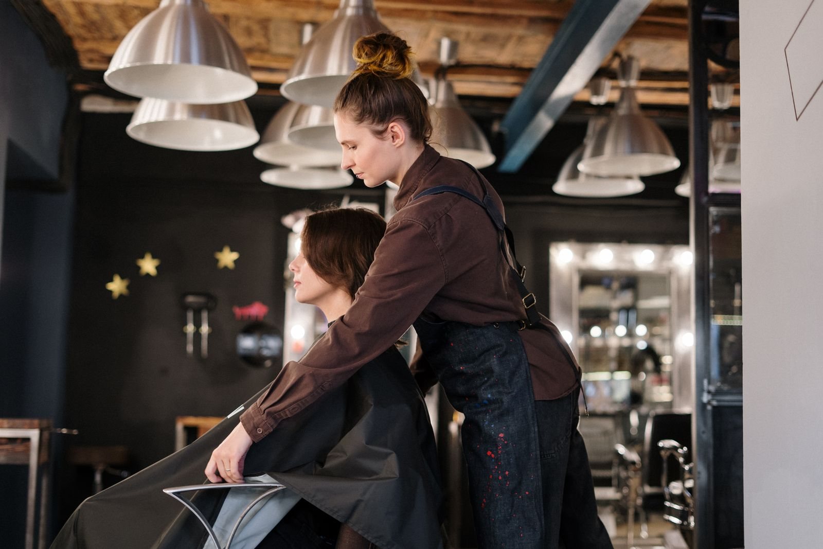 A hairstylist working with a client in a contemporary salon.
